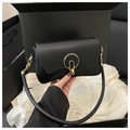 Minimalist black leather crossbody bag with distinctive gold buckle and chain strap - Black