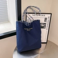 Große marineblaue Canvas-Einkaufstasche mit bunten Griffen und Karofutter - Blau