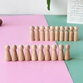 Macro shot of unfinished smooth wooden peg dolls for DIY painting and crafts - Couples Combination Style
