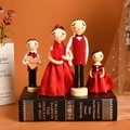 European wooden family doll set with red silk outfits on a book background - Red Wedding Dress Style