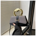 Detail of tweed and black leather handbag featuring a unique gold metal handle and H-buckle - Black