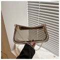 Detailed close-up of a clear PVC handbag with gold chain strap and beige leather trim - Khaki