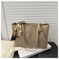 Detail of khaki tote bag with decorative scarf on handle and circular buckle pocket - Khaki