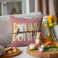 Pink Easter bunny pillow cover with BUNNY text and rabbit ear silhouette on white sofa - Pink BUNNY funny Letters (YME24-12)
