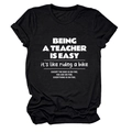 Flat lay of black cotton teacher t-shirt featuring a funny white slogan print design - Black (White Font)