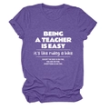 Flat lay view of a purple crew neck cotton T-shirt featuring a white teacher quote print - Purple (White Font)