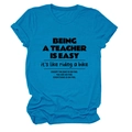 Detail of navy blue t-shirt with rolled sleeves and Being a Teacher Is printed text - Lake Blue (Black Font)