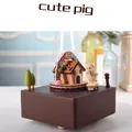 Handcrafted wooden music box featuring a cute pig on skateboard and a candy house model - Candy House Pig (1541)