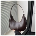Detail view of coffee brown crescent underarm bag with silver bow pendant and adjustable strap - Coffee
