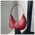 Close-up of red matte leather hobo bag with a delicate silver bow metal ornament - Red