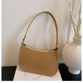 Detailed texture of camel pebble leather underarm bag with silver zipper closure - Brown