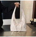 Detail of cream leather tote bag featuring a large bow and heart-shaped metal logo - Off White