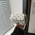 Chic white mini crossbody bag with black polka dot print and faux leather finish - White