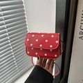 Retro red crossbody bag with white polka dots featuring a minimalist flap design - Red