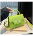 Detail view of bright green structured handbag with metal lock and top handle - Green