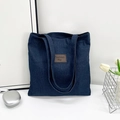 Minimalist large capacity tote bag in dark blue denim with brown leather fashion label - Fashion Patch Style