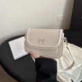 Minimalist beige PU leather crossbody bag featuring a delicate gold bow decoration - White