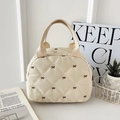 Beige quilted handbag with brown bow embroidery and a woven handle in a stylish look - Off White