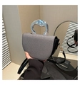 Detailed view of semi-circular silver fabric bag with wavy silver metal handle and black strap - Black