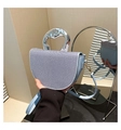 Detail of light blue saddle bag with textured fabric and shiny silver metal handle - Blue