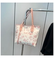Detail of a large tote bag with pink graffiti patterns and stylish double shoulder straps - Pink