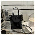 Glossy black patent leather tote bag with Fashion Bag embossing on metallic shelf - Black