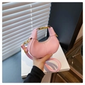 Close-up of pink crescent mini bag showing matte leather texture and gold hardware details - Pink