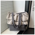 Detail shot of the ruffled lace trim on a charcoal grey canvas tote bag with soft lighting - Dark Gray