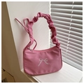 Close-up of pink pleated baguette bag featuring delicate white embroidered bow detail - Rose Pink