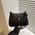 Minimalist black matte leather saddle bag featuring unique braided knot strap details - Black