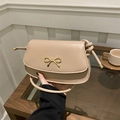 Beige crossbody bag with gold metal bow buckle and elegant knotted leather shoulder strap - Khaki