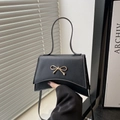 Elegant black bow-knot crossbody bag with gold hardware and curved base design - Black