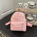 Pink corduroy mini backpack with double zippers shown in a cozy home setting - Pink
