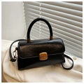 Detail of glossy black leather tote bag with elegant gold metal lock and textured surface - Black