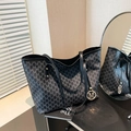 Large black tote bag with repeated M-letter pattern and gold logo pendant - Black