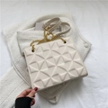 Chic cream white crossbody bag featuring geometric pyramid texture and gold chain strap - Off White