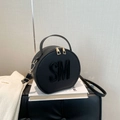 Chic black round handbag with SM embossed logo and adjustable crossbody strap - Black