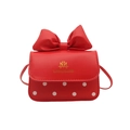 Red bow crossbody bag for kids with white polka dots and gold brand logo detail - Red