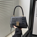 Chic black handbag with crocodile pattern flap and gold clasp on a crossbody strap - Black
