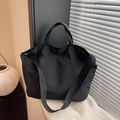Minimalist black canvas tote bag with large capacity and versatile shoulder straps - Black