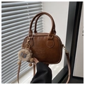 Close-up of caramel brown retro PU leather handbag with lucky lettering and plush bear charm - Brown with Pendant
