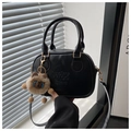 Detail of black shell bag with lucky LHCO Smu embossing and brown plush pendant charm - Black With Pendant