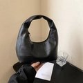 Modern black patchwork leather hobo bag with geometric stitching and gold zipper detail - Black