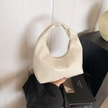 Minimalist beige handbag featuring geometric stitching and soft matte synthetic leather - White