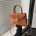 Caramel brown square leather handbag with golden floral buckle and envelope flap detail - Brown