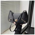 Detail of black crescent shoulder bag with gold twist lock and metallic hardware accents - Black
