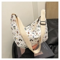 Close-up of pleated white crossbody bag with cute cartoon prints and wide woven strap - White Cartoon Dog and Cat Print