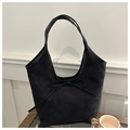 Detail of black suede hobo tote bag featuring a leather bow and premium matte texture - Black