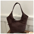 Close-up of matte dark brown tote bag featuring elegant leather bow detail and soft texture - Brown