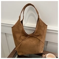 Detail of caramel suede tote bag with elegant bow knot and leather trim finish - Brown